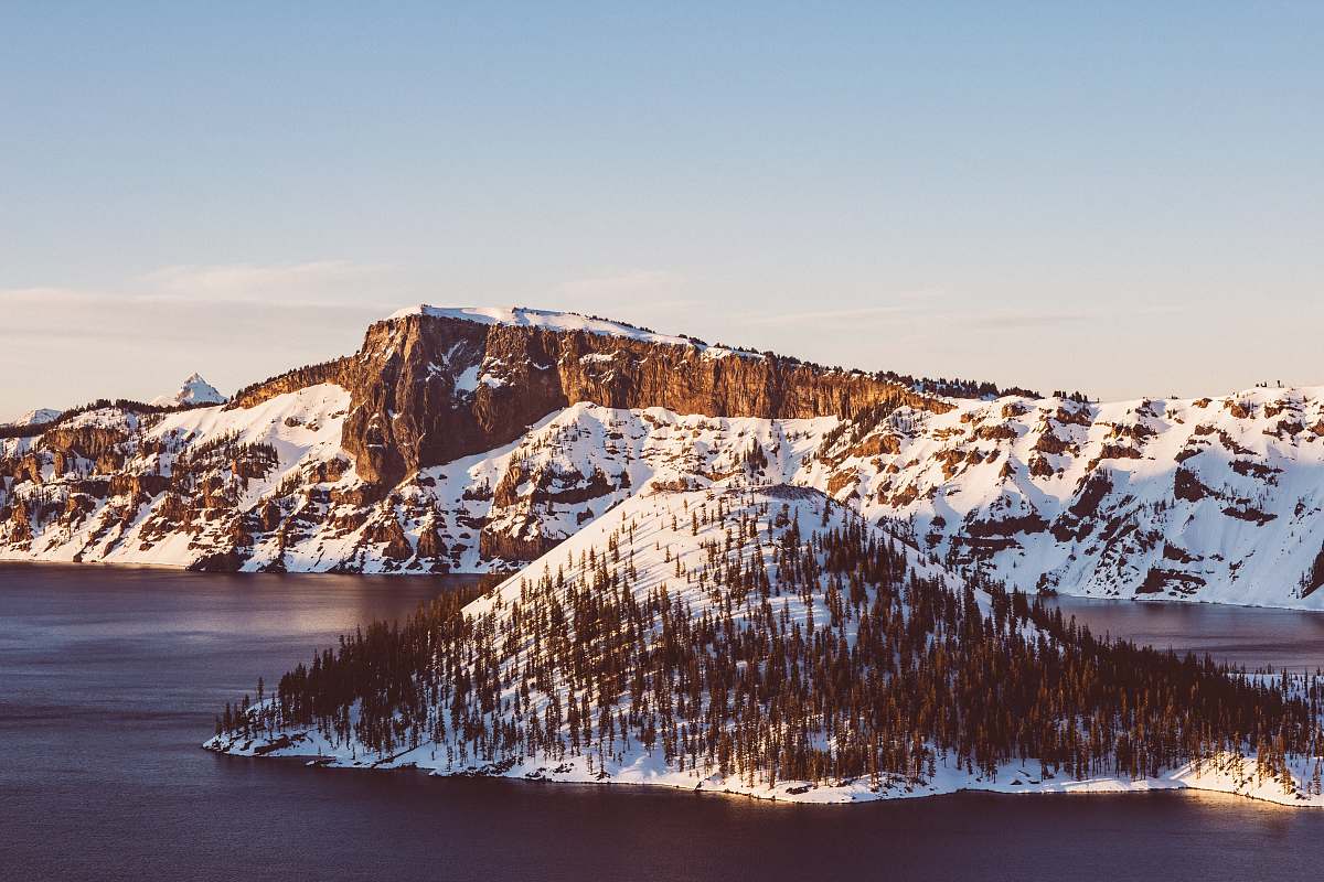 crater lake snow covered islet at daytime nature